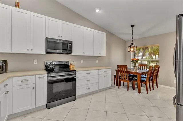 a kitchen with a cabinets and chairs in it