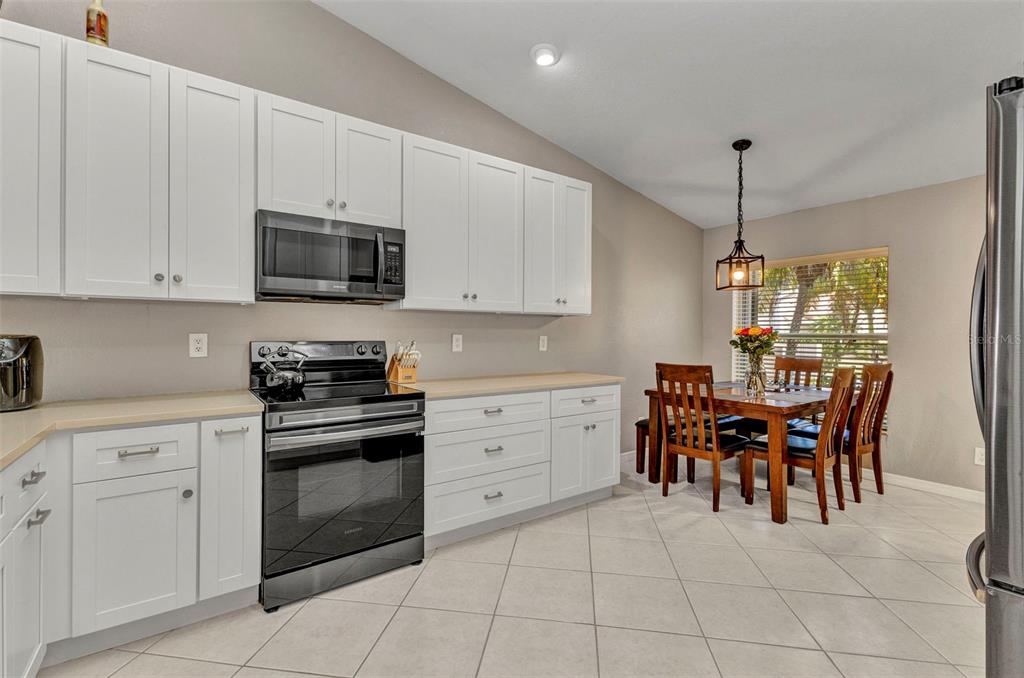 3715 Albacete Circle, Unit 93 Punta Gorda, FL 33950 - Photo 6 of 32 a kitchen with a cabinets and chairs in it