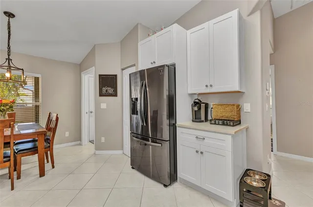 a kitchen with stainless steel appliances a refrigerator and a stove top oven