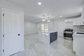 a large kitchen with a refrigerator a stove top oven a sink and dishwasher