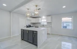a kitchen with a sink and chandelier