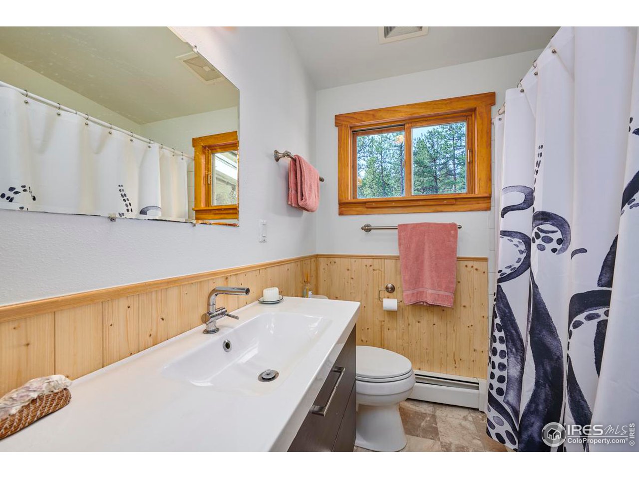 347 Kelly Road East Boulder, CO 80302 - Photo 10 of 30 a bathroom with a sink a toilet and a mirror