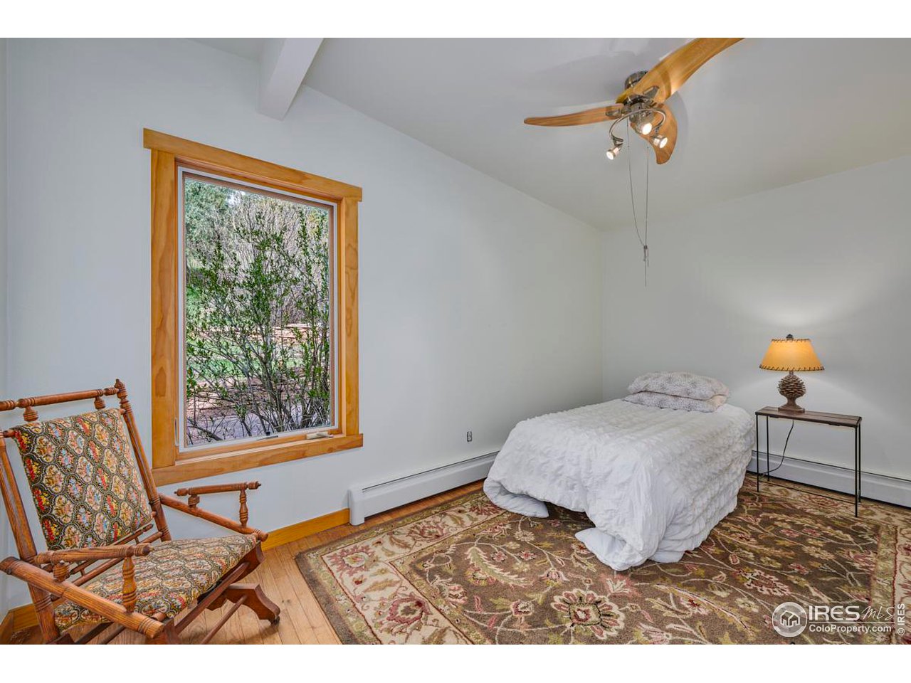 347 Kelly Road East Boulder, CO 80302 - Photo 11 of 30 a bedroom with a bed and a window