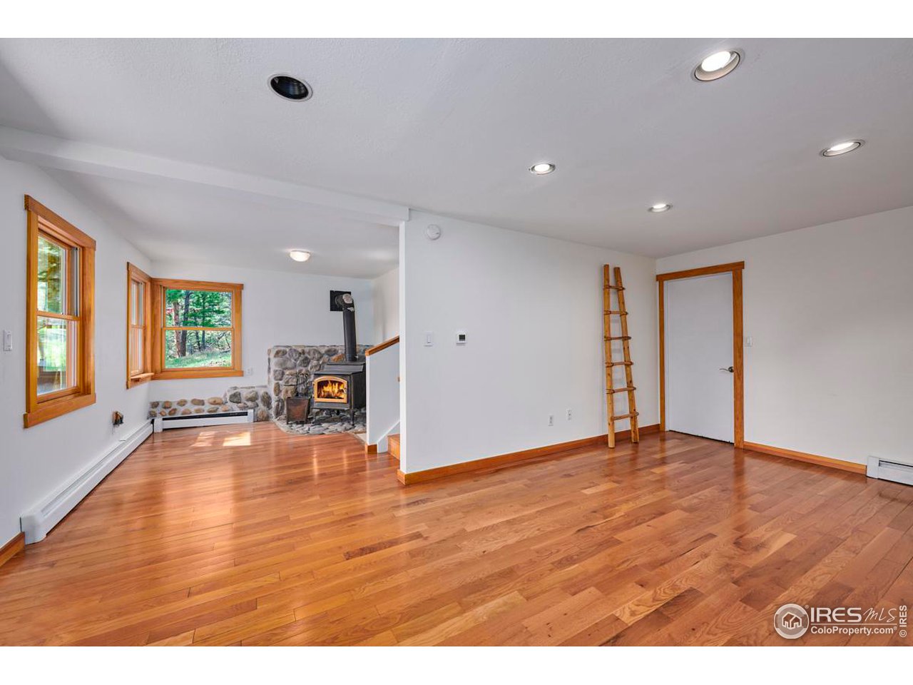 347 Kelly Road East Boulder, CO 80302 - Photo 16 of 30 a view of an empty room with wooden floor and a window