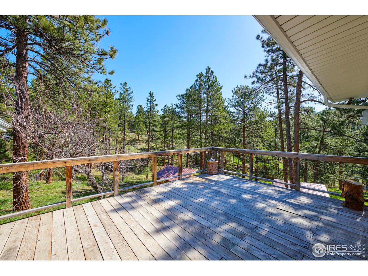 347 Kelly Road East Boulder, CO 80302 - Photo 22 of 30 a view of a balcony with wooden floor and fence