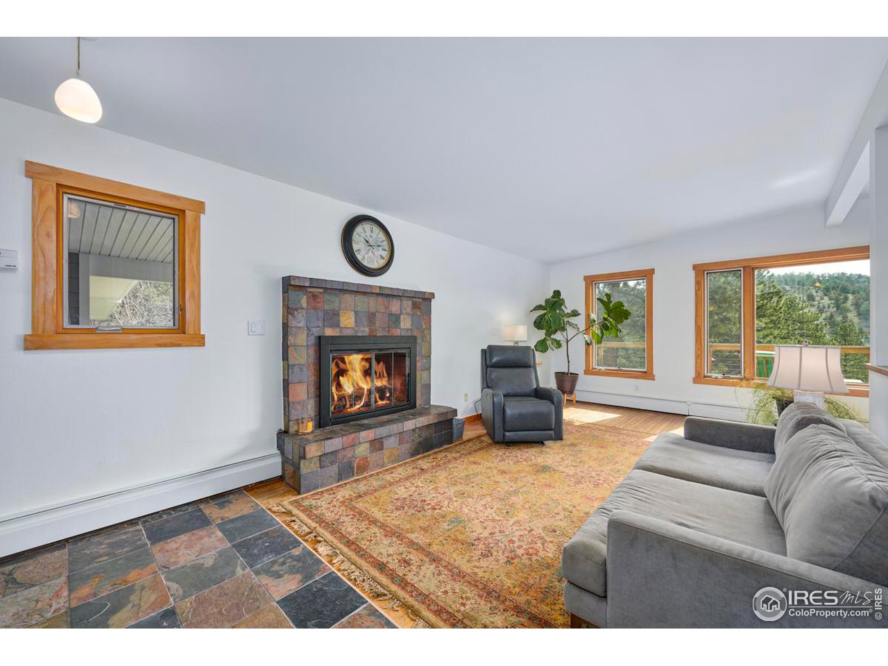 347 Kelly Road East Boulder, CO 80302 - Photo 5 of 30 a living room with furniture a window and a fireplace