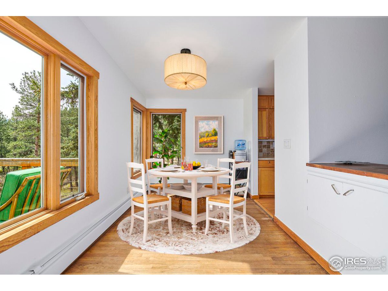 347 Kelly Road East Boulder, CO 80302 - Photo 6 of 30 a dining room with wooden floor and a floor to ceiling window