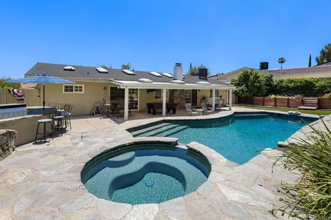 a view of a swimming pool and lounge chair