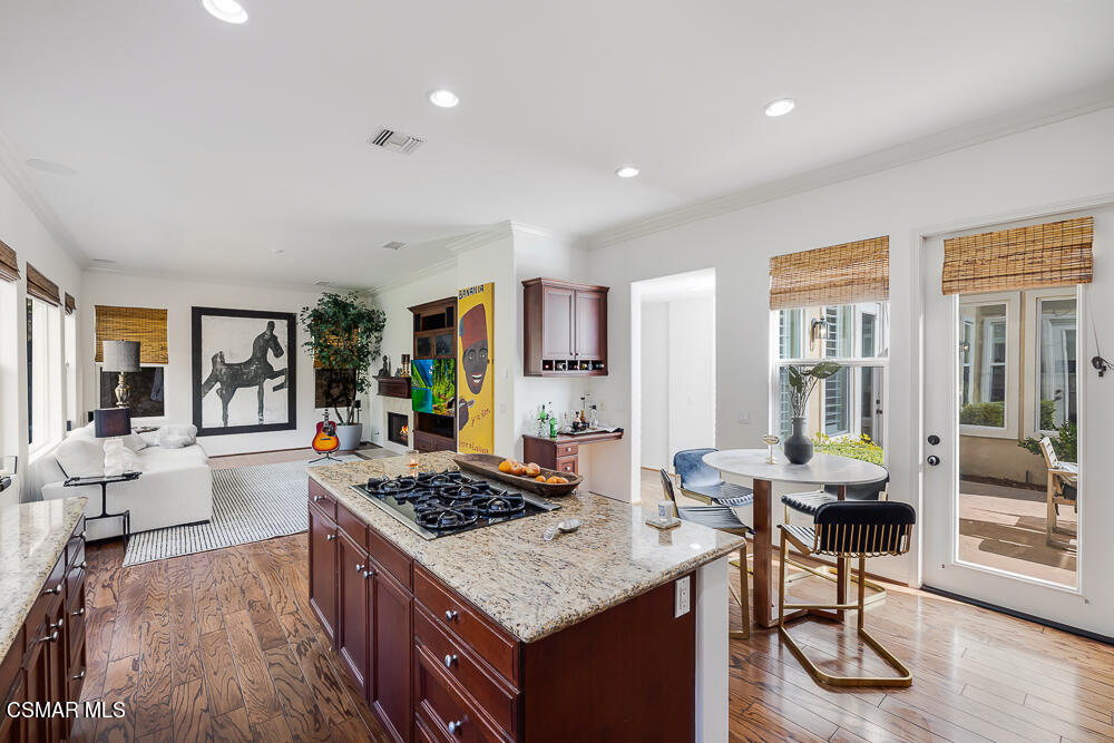 6103 Deerhill Road Oak Park, CA 91377 - Photo 13 of 40 a kitchen with granite countertop a stove and white cabinets