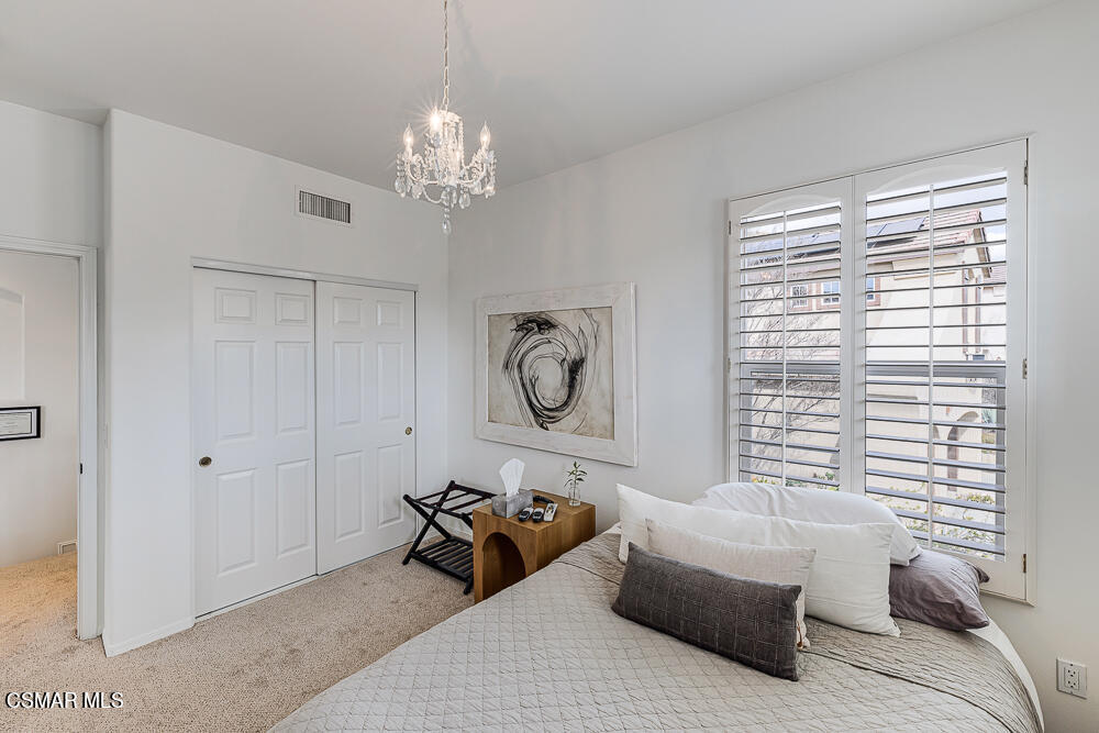 6103 Deerhill Road Oak Park, CA 91377 - Photo 27 of 40 a bedroom with furniture and a large window