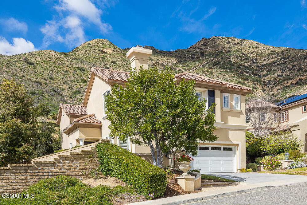 6103 Deerhill Road Oak Park, CA 91377 - Photo 3 of 40 a view of a house with a mountain and trees