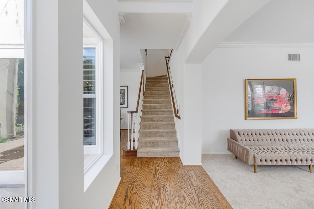 6103 Deerhill Road Oak Park, CA 91377 - Photo 7 of 40 a view of a bedroom with wooden floor and stairs