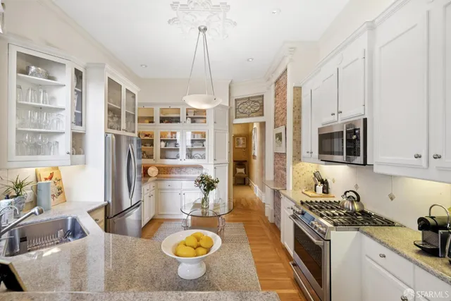 a kitchen with a stove a sink and a refrigerator