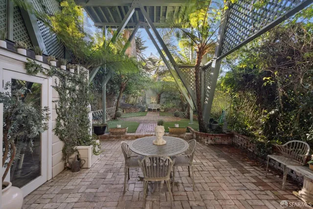 a view of a patio with table and chairs and potted plants