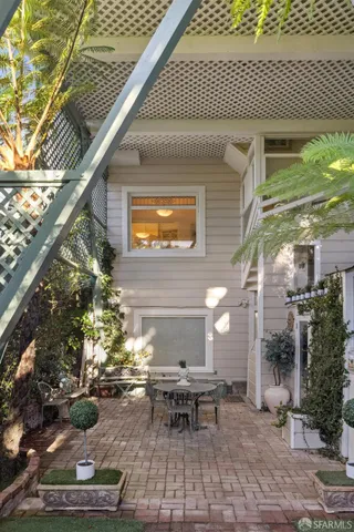 a view of a patio with table and chairs and potted plants