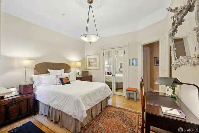 a bedroom with a bed and a chandelier