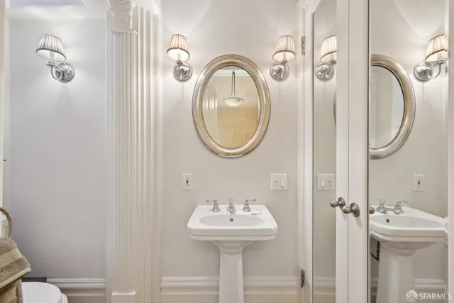 a bathroom with a sink a mirror a toilet and a shower