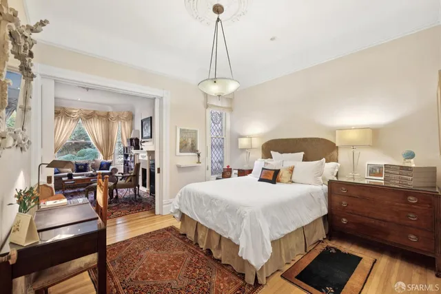 a bedroom with a bed a table and chair