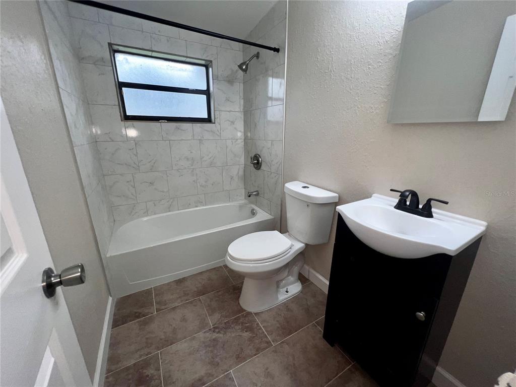 1822 Harding Avenue Sanford, FL 32771 - Photo 18 of 26 a bathroom with a toilet sink and mirror