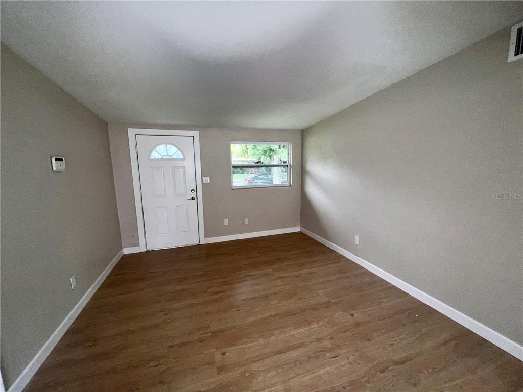 1822 Harding Avenue Sanford, FL 32771 - Photo 2 of 26 an empty room with wooden floor and windows