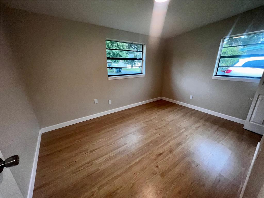 1822 Harding Avenue Sanford, FL 32771 - Photo 21 of 26 an empty room with wooden floor and windows