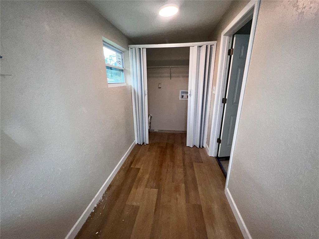 1822 Harding Avenue Sanford, FL 32771 - Photo 9 of 26 a view of a hallway with wooden floor and staircase