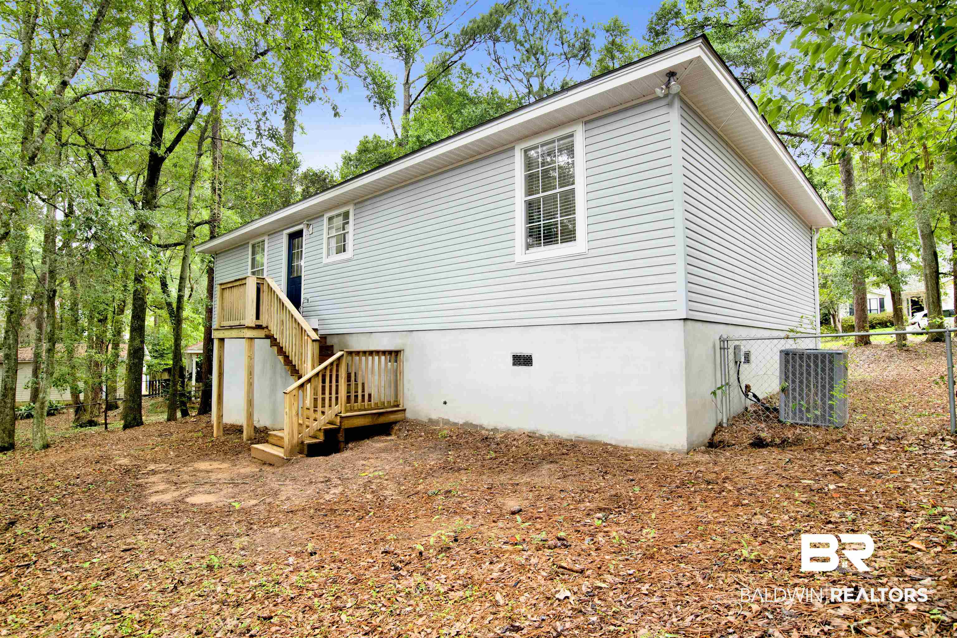 253 Maplewood Loop Daphne, AL 36526 - Photo 27 of 30 Light blue horizontal siding exterior with a partial basement foundation