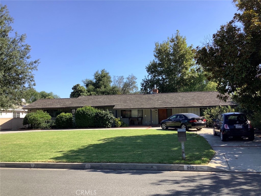 a front view of a house with a yard table and chairs