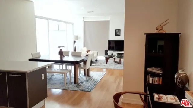 a dining room with furniture and a flat screen tv