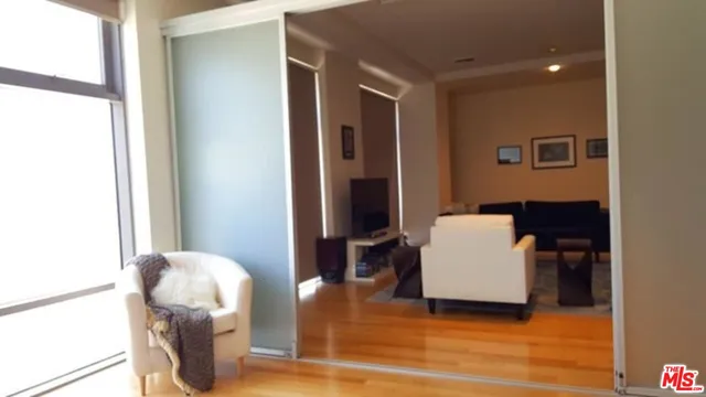 a view of living room with furniture and wooden floor