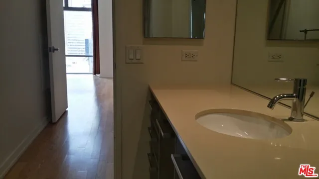 a bathroom with a granite countertop sink