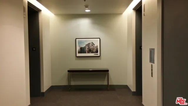 a view of living room with a floor to ceiling window and wooden floor