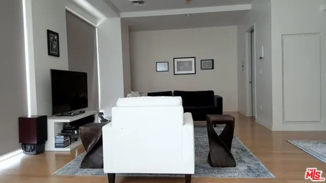 a view of a livingroom with workspace and a couch