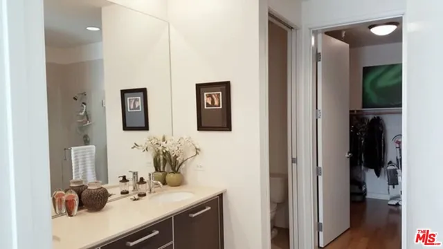 a bathroom with a sink vanity and a mirror