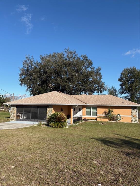 21425 Southwest Plantation Street Dunnellon, FL 34431 - Photo 1 of 54 a view of a house with a yard