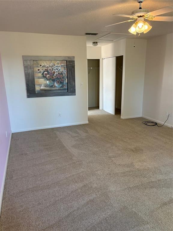 21425 Southwest Plantation Street Dunnellon, FL 34431 - Photo 20 of 54 a view of an empty room with a chandelier fan