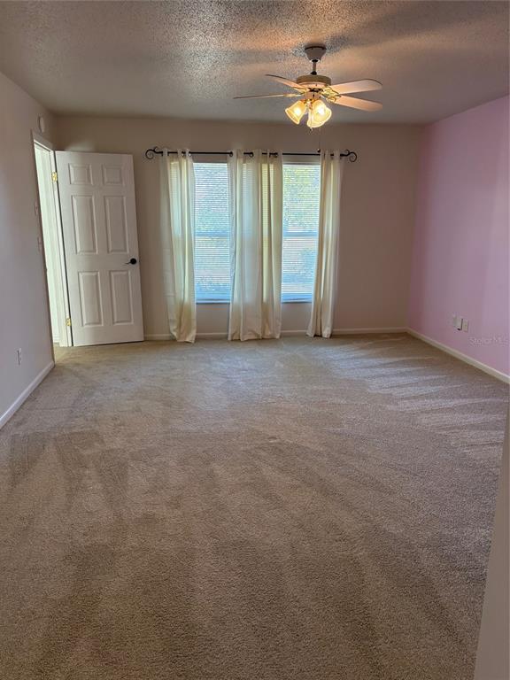 21425 Southwest Plantation Street Dunnellon, FL 34431 - Photo 22 of 54 an empty room with windows and fan chandelier