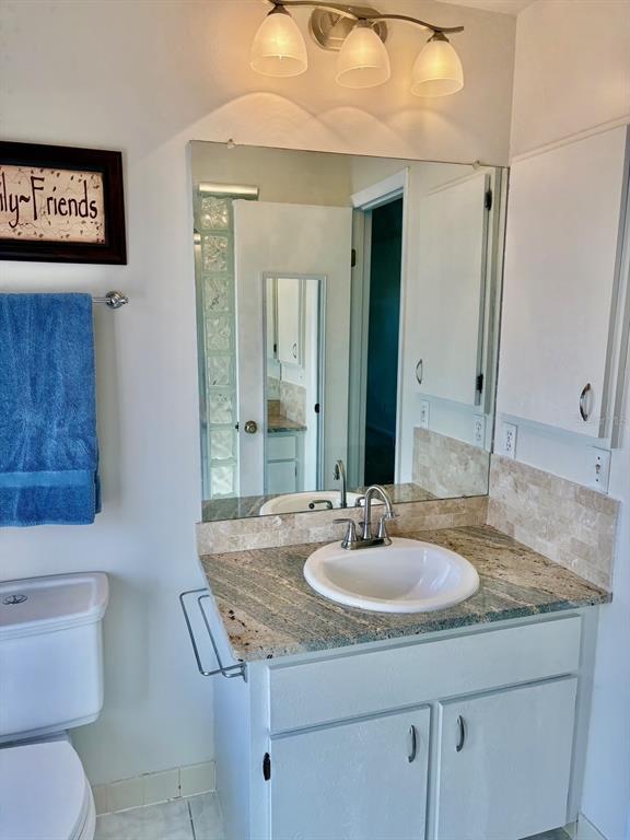 21425 Southwest Plantation Street Dunnellon, FL 34431 - Photo 26 of 54 a bathroom with a sink a toilet and a mirror