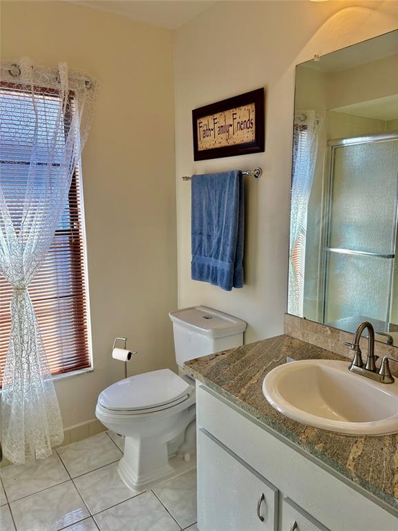 21425 Southwest Plantation Street Dunnellon, FL 34431 - Photo 27 of 54 a bathroom with a granite countertop toilet sink and mirror