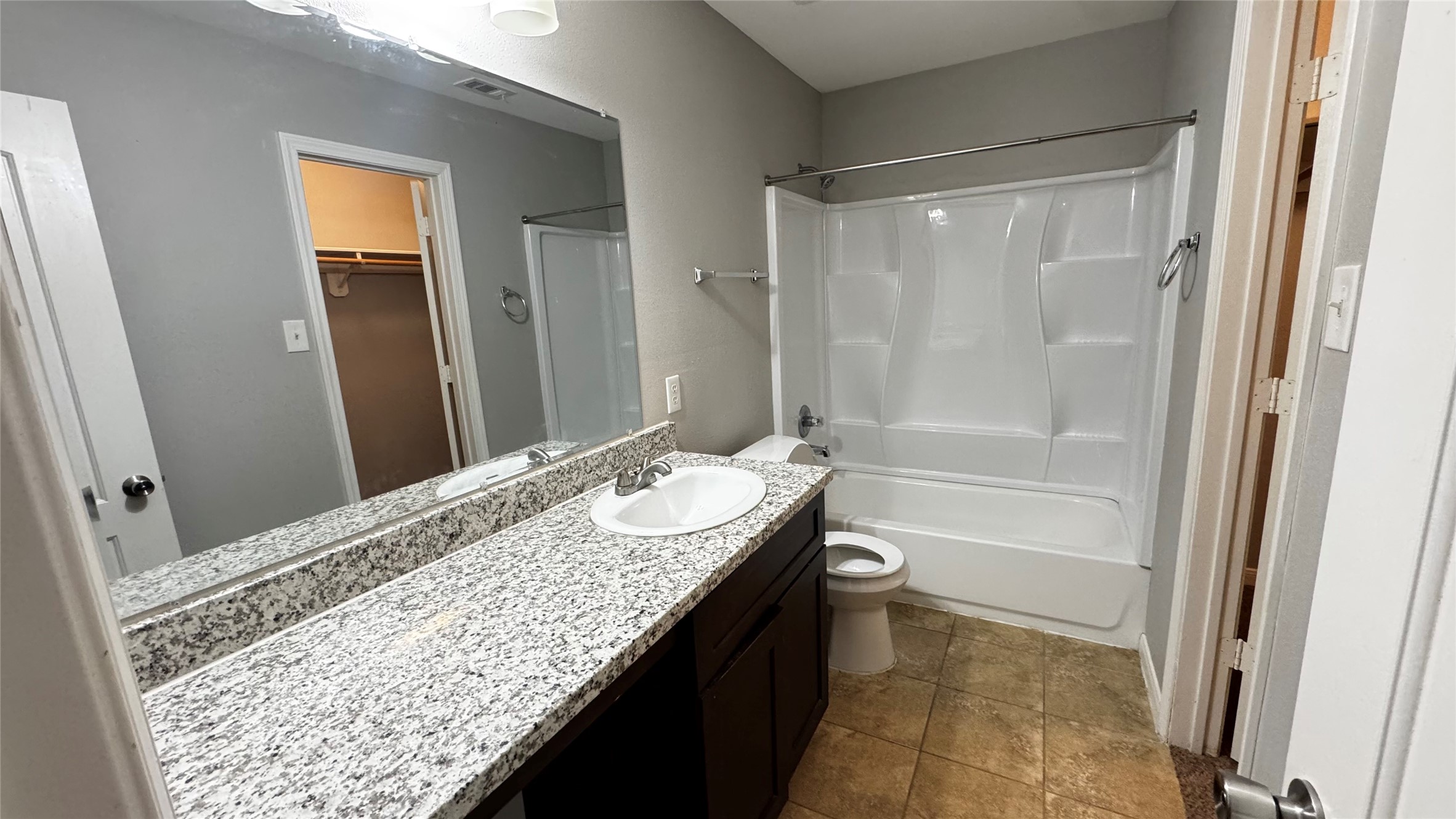 6614 Bluestone Springs Lane Spring, TX 77379 - Photo 11 of 21 a bathroom with a granite countertop sink a toilet and shower