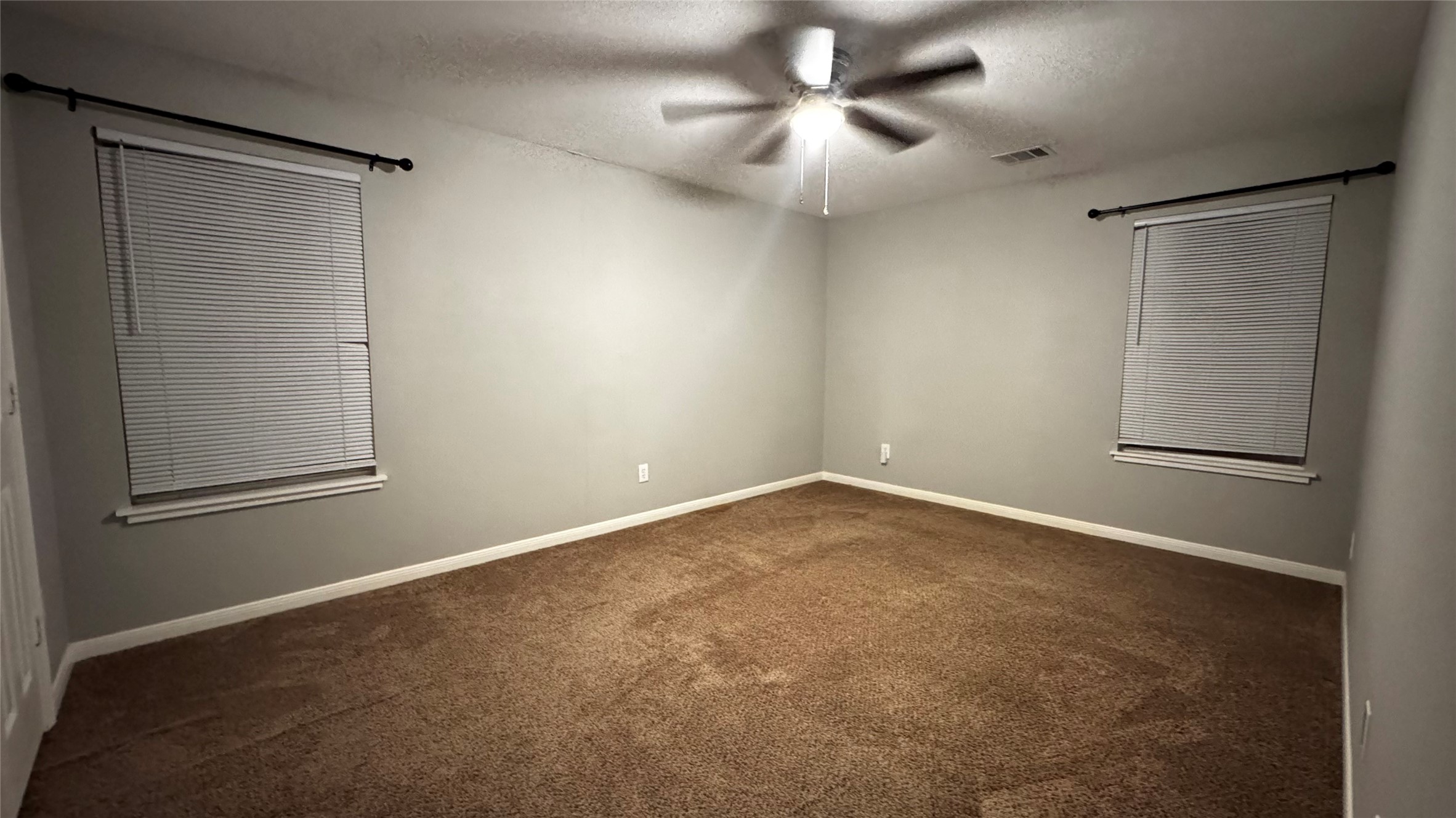 6614 Bluestone Springs Lane Spring, TX 77379 - Photo 18 of 21 an empty room with a ceiling fan and a window