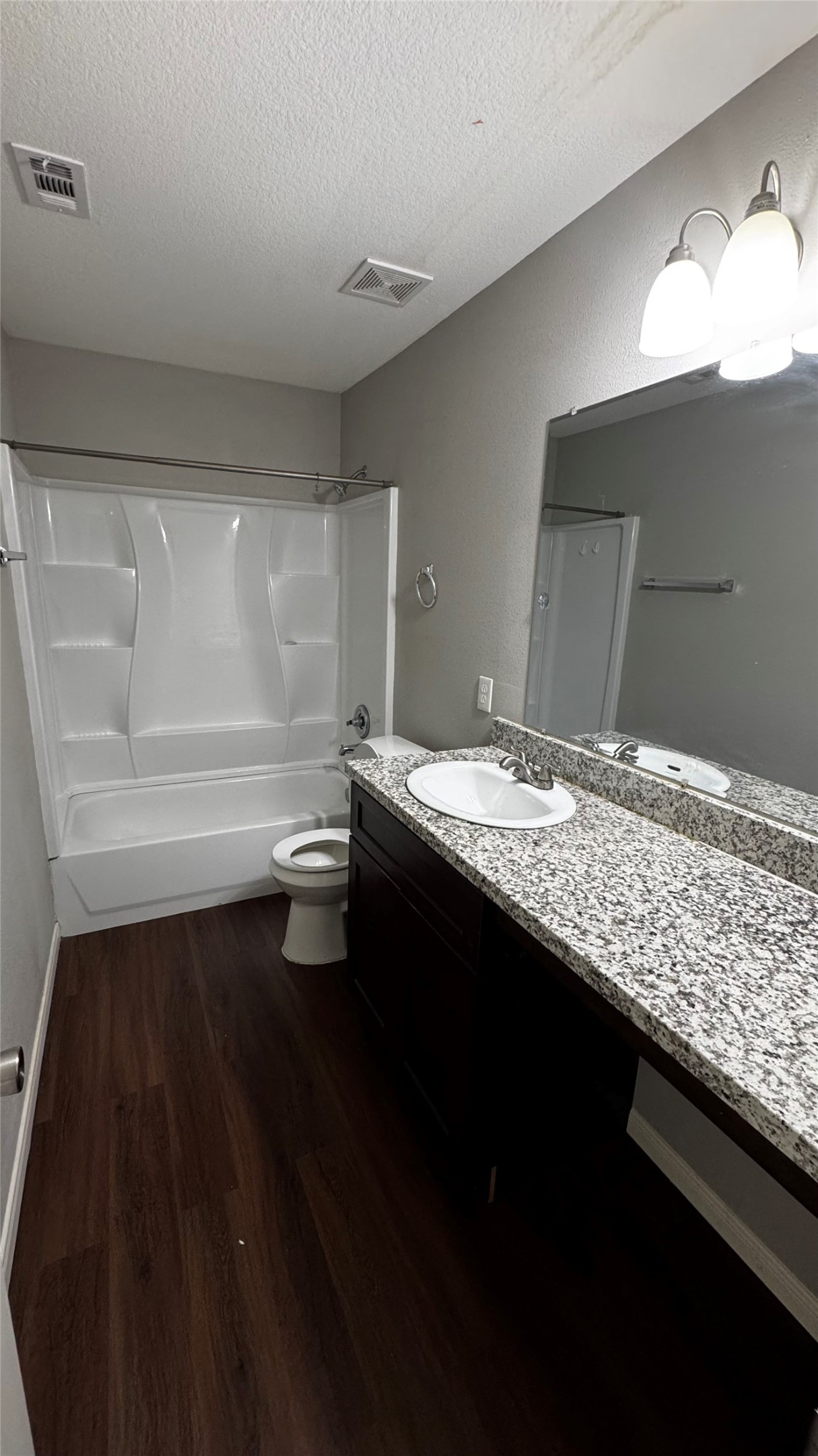 6614 Bluestone Springs Lane Spring, TX 77379 - Photo 20 of 21 a bathroom with a granite countertop sink a toilet a vanity and mirror
