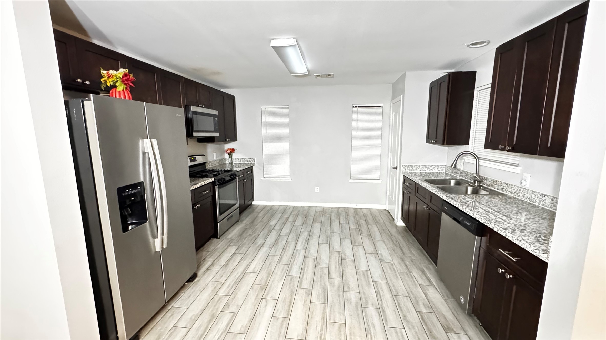 6614 Bluestone Springs Lane Spring, TX 77379 - Photo 6 of 21 a kitchen with granite countertop a refrigerator stove and sink
