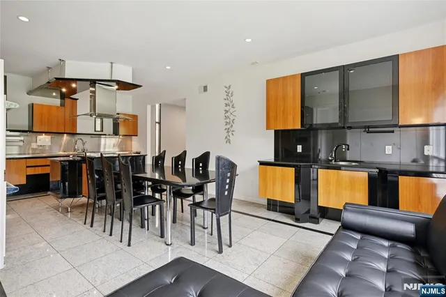a dining room with furniture and a window