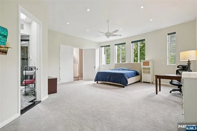a living room with furniture and a book shelf