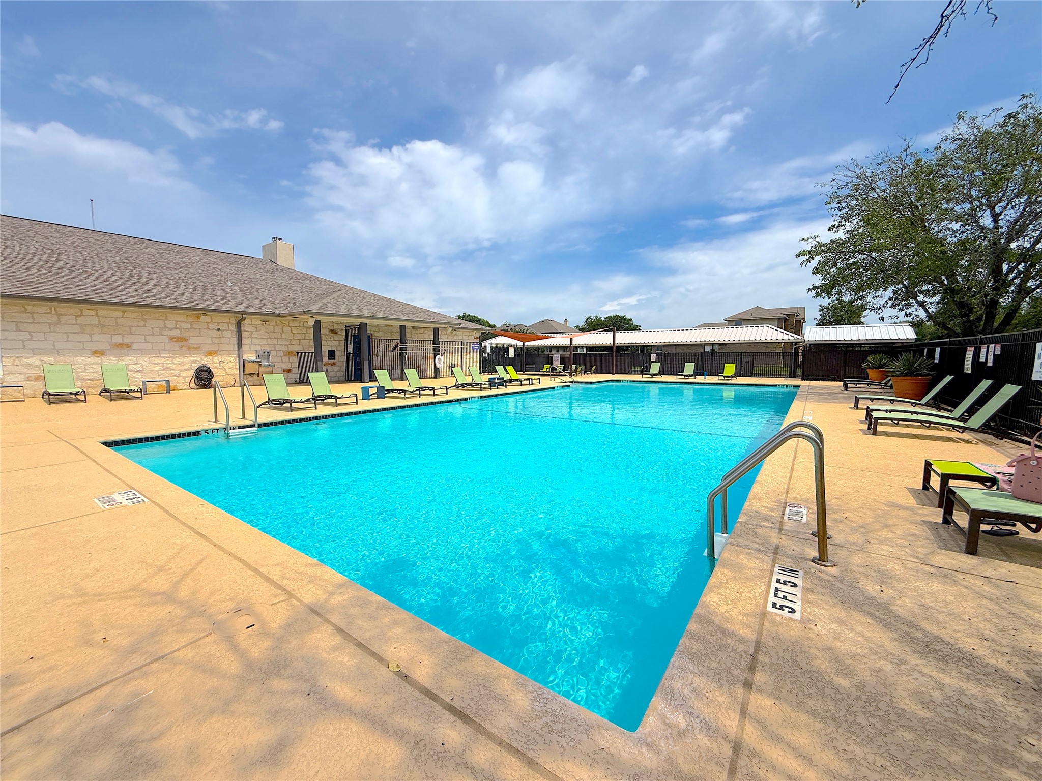 16829 Ruggio Road Pflugerville, TX 78660 - Photo 36 of 40 a view of a swimming pool with a lounge chairs