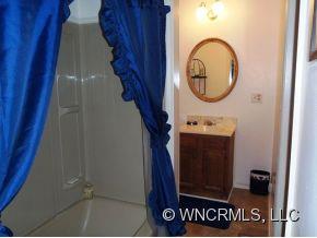 295 Roper Loop Road Rutherfordton, NC 28139 - Photo 11 of 12 a bathroom with a sink and a mirror