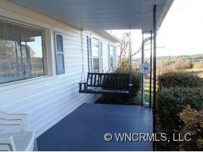 295 Roper Loop Road Rutherfordton, NC 28139 - Photo 3 of 12 a view of a porch with a table and chairs
