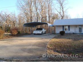295 Roper Loop Road Rutherfordton, NC 28139 - Photo 4 of 12 a car parked in front of a white house