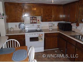 295 Roper Loop Road Rutherfordton, NC 28139 - Photo 6 of 12 a kitchen with stainless steel appliances granite countertop a stove a sink and a microwave